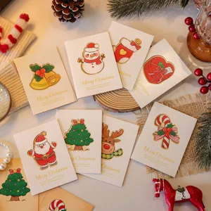 Detail view of hollow-out Christmas cards featuring Santa and festive reindeer illustrations
