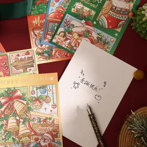 Detail view of a blank Christmas card with handwritten message and a vintage fountain pen.