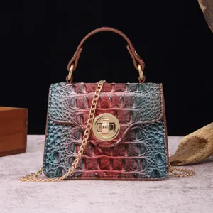 Close-up view of a vintage crocodile embossed leather handbag with gold chain strap