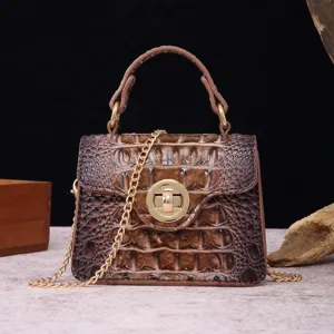 Detailed view of vintage brown croco embossed leather handbag with gold chain strap