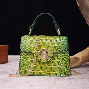 Detailed view of the luxury green crocodile pattern handbag with elegant gold twist lock hardware