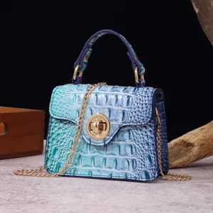 Close-up detail of a vintage blue crocodile embossed handbag with gold chain strap