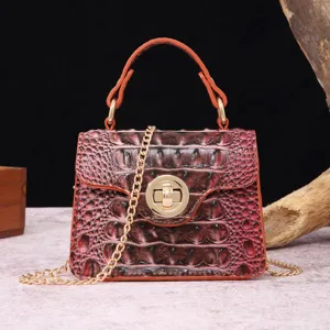 Detailed view of the gradient crocodile pattern and gold-tone twist lock on the handbag