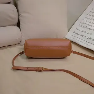Detailed bottom and strap view of a retro brown faux leather doctor crossbody bag