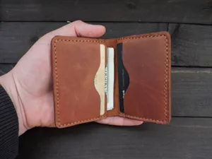 Detail view of vintage crazy horse leather cardholder with cards and cash