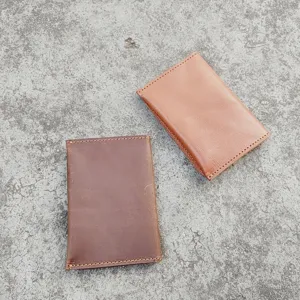 Close-up detail of retro crazy horse leather card holders in dark brown and tan colors.