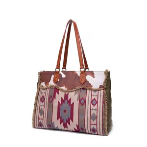 Detail of Bohemian canvas tote bag with cow print and geometric woven patterns