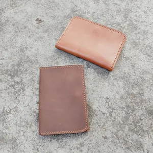 Top view of two vintage crazy horse leather card holders in tan and dark brown cowhide