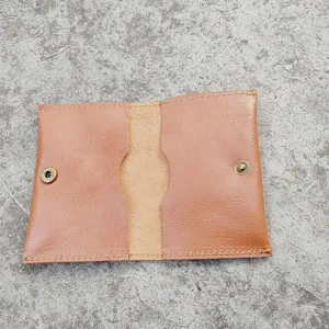 Detailed open view of a vintage tan crazy horse leather card holder with brass snap