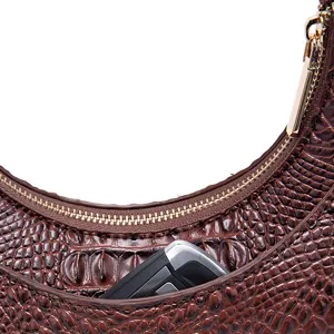Primo piano della borsa sottobraccio marrone con trama a coccodrillo e cerniera