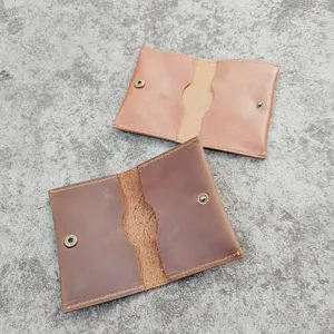 Detailed open view of vintage crazy horse leather card holders in two shades of brown