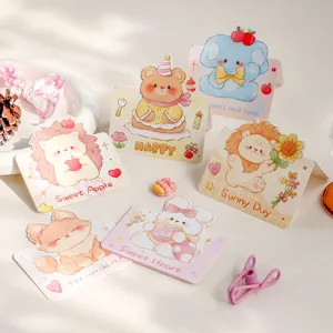 Close-up detail view of cute cartoon animal greeting cards with soft pastel illustrations.