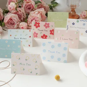 Detail of assorted minimalist floral folded cards featuring various warm English wishes