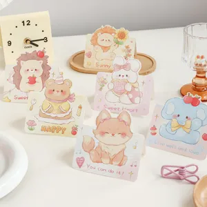 Close-up of various cute cartoon animal greeting cards with inspirational quotes