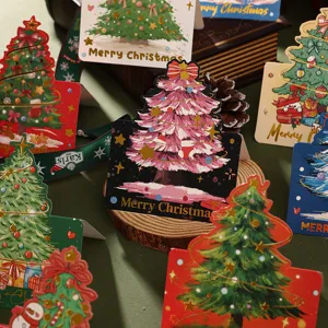 Detail of assorted Christmas tree shaped greeting cards with gold foil stamping