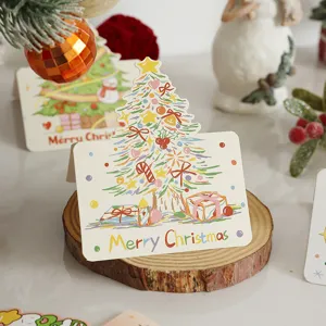 Macro view of a colorful Christmas tree gift card displayed on a wooden stand