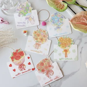 Detailed view of various hand-painted flower bouquet greeting cards for holiday gifts.