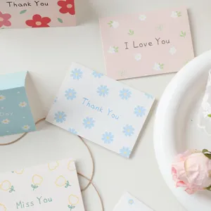 Close-up of assorted floral mini greeting cards with Thank You and I Love You text