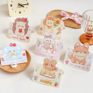 Detailed view of multiple cute cartoon animal folding greeting cards with sweet messages.