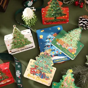 Gold foiled Christmas tree greeting cards with festive holiday decorations