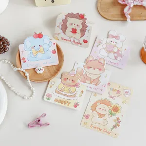 Close-up showing a collection of cute cartoon animal greeting cards with various characters.