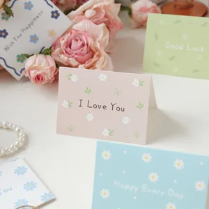 Close-up of pink floral greeting card with 'I Love You' message in a gift setting