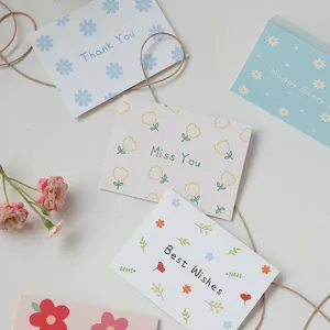 Close-up detail of floral folding greeting cards with 'Best Wishes' and 'Thank You' text