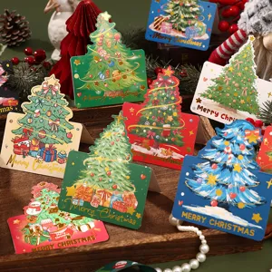 Variety of Christmas tree greeting cards with elegant gold foil lettering on a wooden display