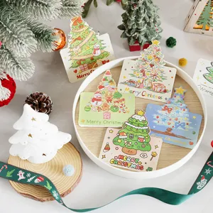 Assorted cartoon Christmas message cards with festive tree illustrations in a tray