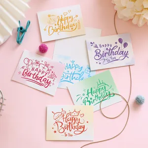 Detailed view of colorful hand-drawn style birthday greeting cards on pink background