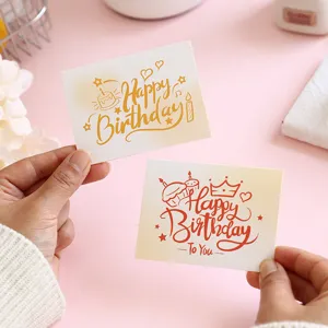 Close-up of creative doodle style Happy Birthday greeting cards on pink background.