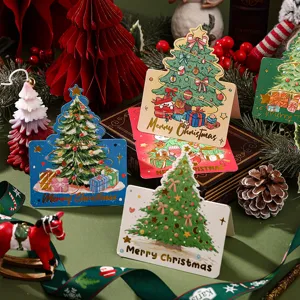Macro detail of festive gold-stamped Christmas tree greeting cards in a cozy setting.