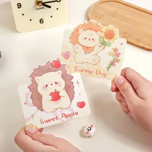 Close-up of cute cartoon lion and hedgehog greeting cards featuring sweet illustrations.