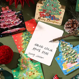 Close-up detail of gold foil Christmas tree greeting card showing message space area
