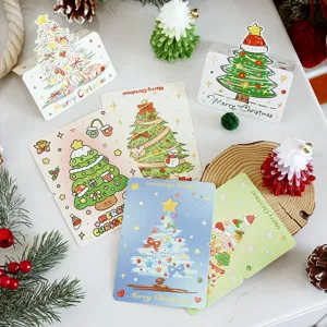 Detail of cartoon Christmas tree greeting cards with festive illustrations and props.