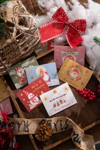 Detailed view of various colorful Christmas greeting cards with cute cartoon illustrations.