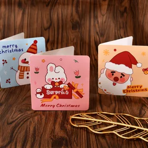 Close-up view of various colorful cartoon-style square folding Christmas greeting cards