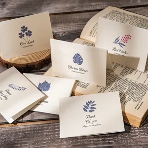 Detail of vintage botanical greeting cards with gold and blue floral patterns.