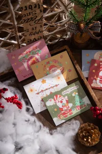 Detailed view of festive Christmas trifold greeting cards with cute cartoon illustrations