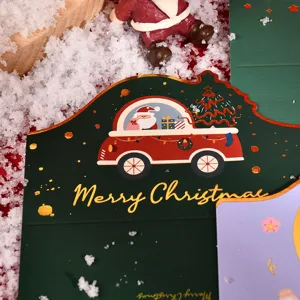 Close-up of a gold foil die-cut Christmas greeting card featuring a Santa car design