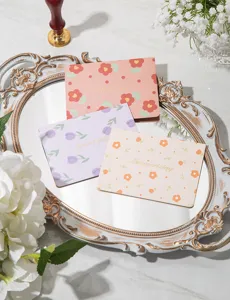 Detail showing gold-stamped floral greeting cards on a vintage tray for gifts