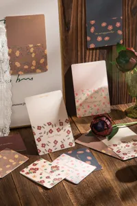 Détail de cartes de vœux vintage à fleurs avec des citations dorées et leurs enveloppes