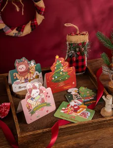 Festive gold-stamped Christmas cards featuring cute cartoon animals and holiday greetings
