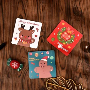 Close-up of three square Christmas cards with cute cartoon reindeer and gingerbread man.
