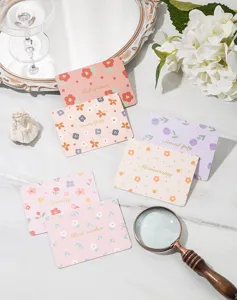 Close-up of floral greeting cards with elegant gold foil lettering and various patterns