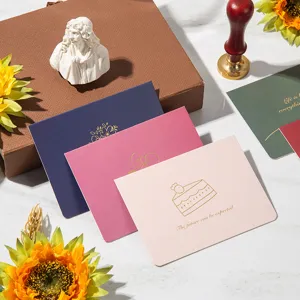 Detailed macro view of elegant gold foil greeting cards with inspirational English text.