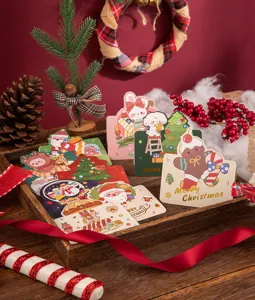 Detail view of cute cartoon Christmas gold foil greeting cards in a festive setting
