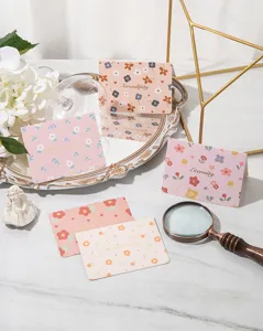 Detailed view of floral gold-stamped greeting cards with various festive designs.