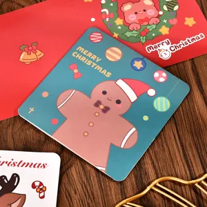 Close-up detail of cartoon gingerbread man design on square green Christmas card