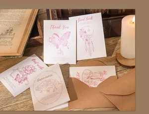 Macro view of vintage-style greeting cards featuring elegant pink illustrations and envelopes